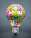 Colorful puzzle pieces forming a lightbulb Royalty Free Stock Photo