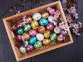 Colorful quail Easter eggs in a wooden box Royalty Free Stock Photo