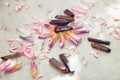 Colorful quartz crystals with pink rose leaves on wooden structure