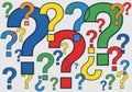 Colorful question marks of various sizes are scattered across a Royalty Free Stock Photo