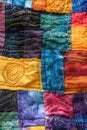 Colorful quilted fabric with geometric stitching. Textile art close-up. Modern quilting design