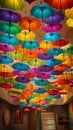 A colorful and quirky image of rainbow umbrellas hanging upside down from the ceiling creating a unique and eye-catching decor