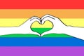 Colorful rainbow background with a heart of silhouette hands. LGBTQ transgender symbol