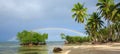 Colorful rainbow over caribbean sea and green palms.Travel background. Royalty Free Stock Photo