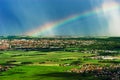 Colorful rainbow over the green fields and vineyards Royalty Free Stock Photo