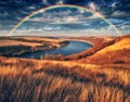 Colorful rainbow over river canyon. autumn landscape Royalty Free Stock Photo