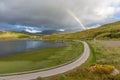 Colorful Rainbow over the road to Unstad in Lofoten islands, Norway Royalty Free Stock Photo