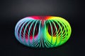 Colorful rainbow spiral toy for play on black background. Royalty Free Stock Photo