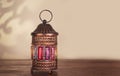 Colorful Ramadan lantern fanos on a wooden table