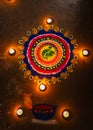Colorful rangoli with lighted candles at festival at night Royalty Free Stock Photo