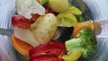 Colorful raw vegetables blending inside blender in super slow motion close up.