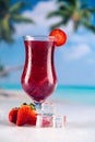Colorful red cold drink on a beach, summer background Royalty Free Stock Photo