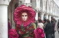 A colorful red costume for the Venice Carnival in Piazza San Marco Royalty Free Stock Photo