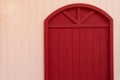 Red door on orange beige wall architecture background Royalty Free Stock Photo