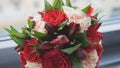 Colorful - red and green - wedding flowers - bride`s bouquet at window, close up Royalty Free Stock Photo