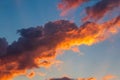 Colorful red and orange fluffy clouds at blue sky in sunset time, beautiful nature cloudscape Royalty Free Stock Photo