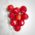 Colorful Red plums in bowl placed in white and black background and reduce the risk of cancer heart disease and diabetes