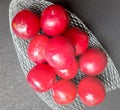 Colorful Red plums in fruit cover placed in black background and reduce the risk of cancer heart disease and diabetes