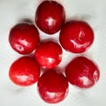 Colorful Red plums kept in white background and reduce the risk of cancer heart disease and diabetes