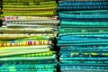 colorful red, purple, pink, yellow, blue, green and orange textile fabrics for sale in a shop Royalty Free Stock Photo