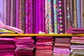 colorful red, purple, pink, yellow, blue, green and orange textile fabrics for sale in a shop Royalty Free Stock Photo