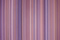 colorful red toned fabric background with soft faded rainbow-colored vertical stripes