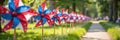 Colorful red, white, and blue pinwheels lining a park pathway Royalty Free Stock Photo