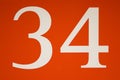 Colorful red and white sign with the number .thirty-four - 34 Royalty Free Stock Photo