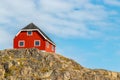 Colorful red wooden house on a hill in Sisimiut, Greenland