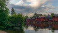 The colorful red wooden warehouses of Porvoo in Finland reflecting in the river at sunset during a warm summer evening - 5