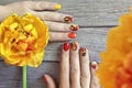 Colorful red Yellow orange manicure with a design