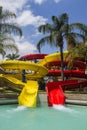 Colorful red and yellow water slide in aqua park. Royalty Free Stock Photo