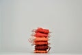 Colorful reddish tones thread spools isolated on a white