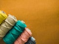 Colorful reels of macrame cord threads or wool shot as copy space background or text background