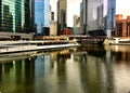 Colorful reflection of cityscape on a freezing Chicago River during winter rush hour commute. Royalty Free Stock Photo