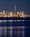 Colorful reflections of the Toronto skyline lights and CN Tower in Lake Ontario