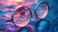 Colorful Reflective Round Glasses Resting on Wet Surface With Vibrant Light Patterns in Evening Royalty Free Stock Photo