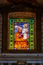 Colorful religious stained glass window inside St Mary of Victory church, Rome