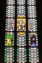 Colorful religious stained glass window in St. Vitus Cathedral i Royalty Free Stock Photo