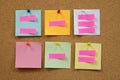 Colorful reminder sticky notes push pins on cork board. Royalty Free Stock Photo