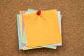 Colorful reminder sticky notes push pins on cork board. Royalty Free Stock Photo