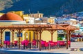 Colorful restaurant with red wooden chairs, Greece