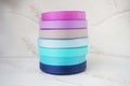colorful ribbons stacked on a grey marbled background. Ribbon for handmade craft DIY