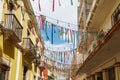 Colorful ribbons strung zigzag between buildings in Campeche, Mexico - horizontal