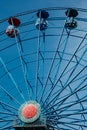 Colorful ride ferris wheel in motion in amusement park on sky background Royalty Free Stock Photo