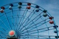 Colorful ride ferris wheel in motion in amusement park on sky background Royalty Free Stock Photo