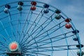 Colorful ride ferris wheel in motion in amusement park on sky background Royalty Free Stock Photo