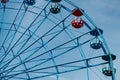 Colorful ride ferris wheel in motion in amusement park on sky background Royalty Free Stock Photo