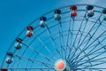 Colorful ride ferris wheel in motion in amusement park on sky background Royalty Free Stock Photo