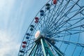 Colorful ride ferris wheel in motion in amusement park on sky background Royalty Free Stock Photo